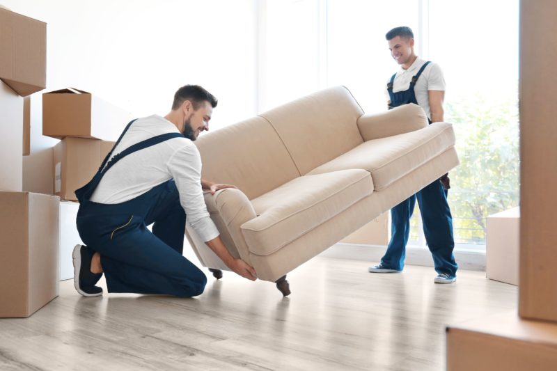 Junk removal professionals removing an unwanted couch